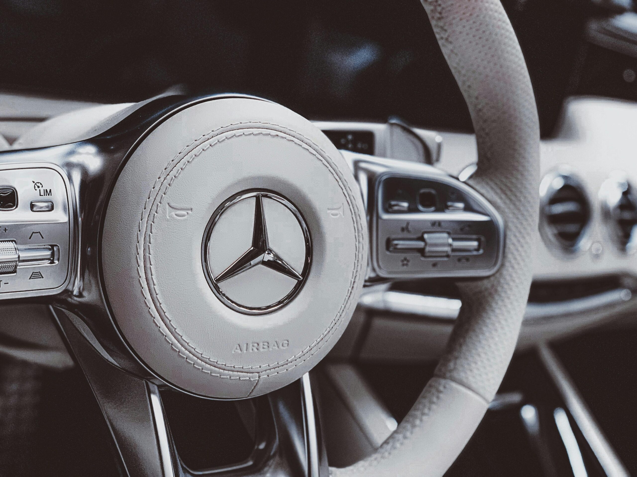 Detailed view of a premium car steering wheel showcasing elegance and sophisticated design.